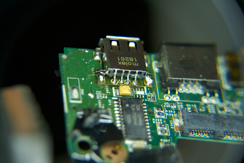 Photo showing new, undamaged USB receptacle soldered on to motherboard PCB